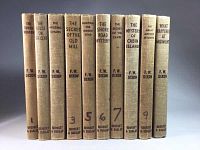Photo of 10 vintage Hardy Boys books with brown covers showing titles and spine details.