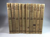 Photo of 10 brown-covered vintage Hardy Boys books aligned on shelf, showing spines with titles and author's name F. W. Dixon, with some spine writing and marks.