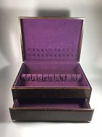 Open wood silver cutlery chest showing purple felt interior with slots for cutlery on lid and main compartment