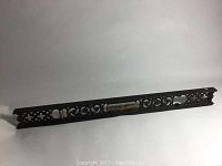 Full length view of the antique cast iron level showing ornate design