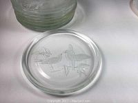 Single thick glass plate with etching of birds on branches visible on underside, showing detailed artwork and clear glass thickness.