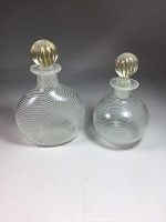 Photo showing the two matching blown glass perfume bottles with white swirl patterns and ribbed aventurine gold dust stoppers from front angle.