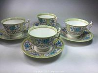 Four Royal Doulton teacups and saucers shown in a group from front angle, highlighting pattern and design details.