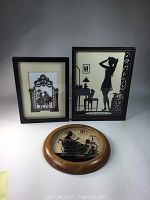 Overall lot with three framed silhouette art pieces showing different sizes and styles