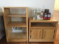 Two wood furniture pieces side by side: on the left an open bookcase, on the right a media cabinet topped with some household items.