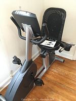 Front perspective view of bike showing seat, pedals, handlebars and console