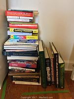Stack of assorted books including dictionaries, quilting guides, and instructional 'For Dummies' titles
