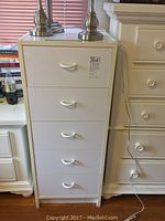 White 5-drawer stack with curved handles on each drawer showing front view