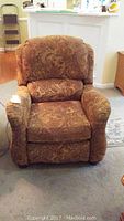 Front view of Havertys recliner chair showing brown patterned upholstery and padded arms.