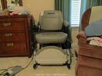 Front view of Hoveround MPV5 chair with charger unit on floor