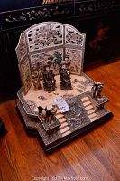 Overall view of the complete carved bone tableau set with screen, figurines and base