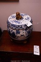 Front view of the jar with lid in place on brass stand