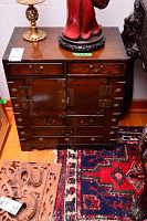 Front view of dark stained wood side cabinet with two small top drawers, central doors and two bottom drawers