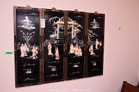 Full view of all four black lacquer panels hung side by side