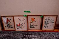 Four framed Asian art prints of floral designs displayed side by side showing overall lot condition