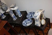 All four nesting tables arranged in descending size order with porcelain items on top