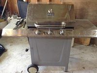 Full view of the Master Chef propane BBQ including side shelves and front panel with three control knobs.