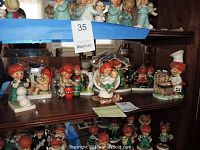 Front shelf display of redheaded child figurines in various scenes