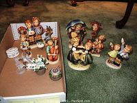 Overview on cardboard tray and carpet of all porcelain figurines, trinket boxes, glass birds and flower basket