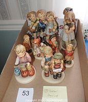 Overhead view of all nine figurines arranged in box