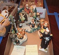 Overall tray showing two Hummelscapes sets on left and back, and Goebel monk figurine on right