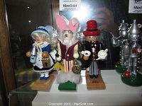 Front view of three Alice in Wonderland nutcrackers displayed in glass case