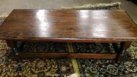 Top view of handmade solid wood colonial style coffee table showing polished surface and leg detail.
