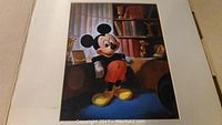 Framed Disney Mickey Mouse reproduction poster showing Mickey standing indoors, detailed background with bookshelf and window curtains.