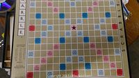 Top view of Scrabble board showing colored premium score squares