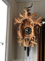 Front view of entire cuckoo clock mounted on wall