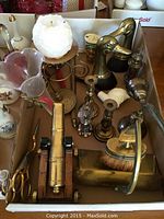 Box contents including duck bookends, bell, cannon, brush, pan and vase stand