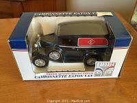 Front and side view of Special Edition Eaton Van in original box showing blue van with Eaton logos and silver detailing.