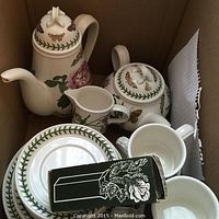 Overview of coffee pot, teapot, creamer, cup and saucer, and plates in cardboard box