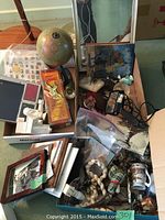 Top view of the box showing all small items including the small globe and decorative items