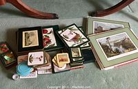 Overview of placemats and coasters with various fruit and scenic prints scattered on carpet near a chair base.