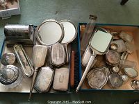 Overview of all silver-plated vanity items arranged on two trays
