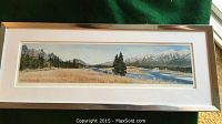 Full view of the framed panoramic landscape artwork with natural scenery and river flowing through.