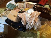 Table top view of assorted handbags and gloves