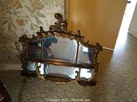 Full front view of the mirror laid on floor showing overall design and panel arrangement