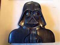 Front view of the black plastic Darth Vader-shaped carrying case