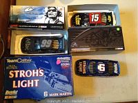 Top view of the three NASCAR die-cast cars in their boxes showing the Stroh's Light #6, Aflac #99, and Number 15 cars.