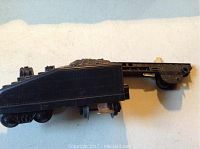 Side view of black missile exploding target car showing wheels and side details