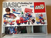 Original boxed LEGO Basic Building Set 720 for ages 7-12, showing various build options on the box front with partially visible LEGO pieces inside.
