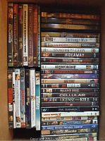 Top view of assorted DVDs showing titles and cases neatly stacked, 43 total DVDs visualized