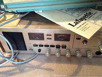 Close-up of front panel of vintage Lafayette radio with meters, control knobs, and power switch