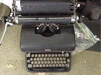 Top-down view of black Royal vintage manual typewriter showing round keys, space bar, and carriage return lever.