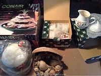 Image showing boxed Conair water fountain, seashell basket, ceramic creamer, and light up Santa house.