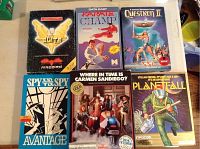 Six boxed Apple game titles: Elite, Karate Champ, Questron II, Spy vs Spy, Where in Time is Carmen Sandiego?, Planetfall