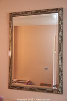 Full view of the bevelled wall mirror showing the rectangular shape and overall frame design.