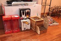 Full lot including boxed Smirnoff glasses, Luigi Bormioli beer glasses, basket with shot glasses, bottle openers, pourers and Labatt's glasses on wood floor